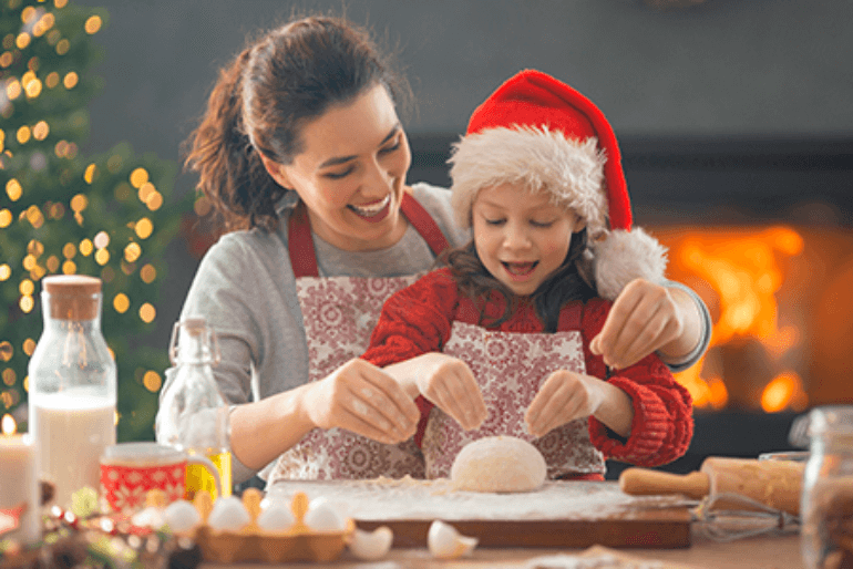 mother-daughter enjoying baking with Christmas theme