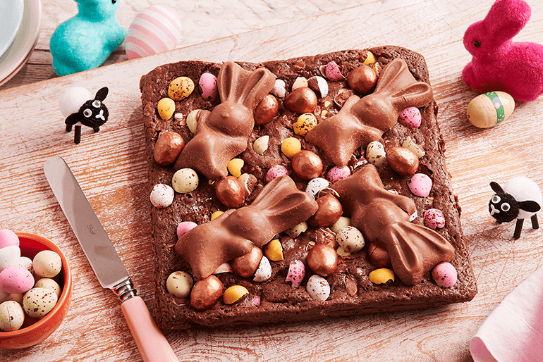 a delicious chocolate brownie topped with colorful mini chocolate easter eggs